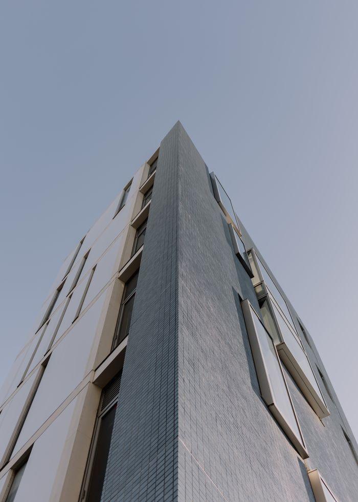 Low angle view of a contemporary building facade in Tokyo, Japan showcasing modern architecture.