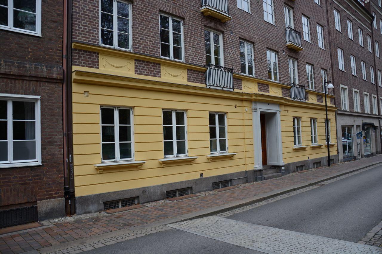 Charming urban street with classic European apartment facade in daylight.